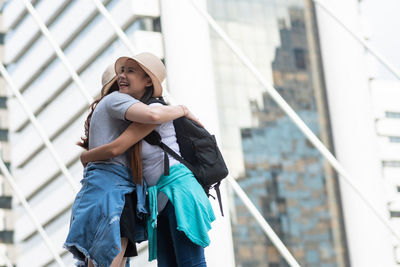 Tourists standing on footpath in city