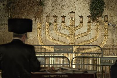 Rear view of man standing against building