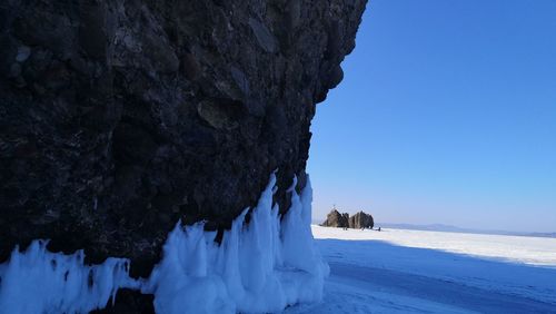 Scenic view of snow covered land against blue sky