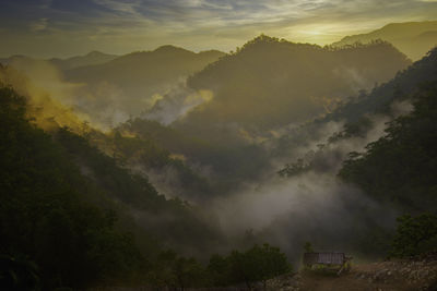 Scenic view of mountains against sky during foggy weather