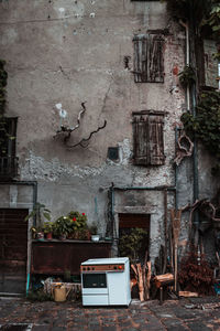 Abandoned and potted plants on old building