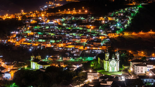 High angle view of illuminated buildings in city at night