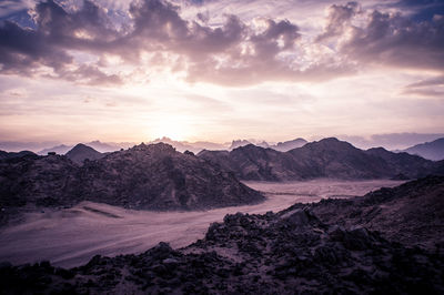 Scenic view of mountains against cloudy sky