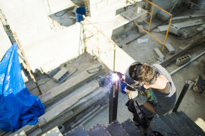 High angle view of man welding on construction site.