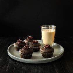 Close-up of cupcakes on table against black background