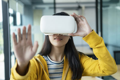 Woman wearing virtual reality simulator 