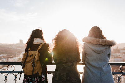 Three happy friends porto bridge sightseeing at sunset. travel, friendship and lifestyle