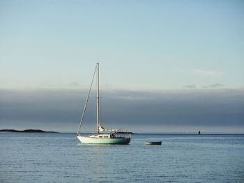 Sailboat sailing on sea against sky