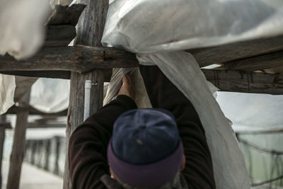 Rear view of man working outdoors