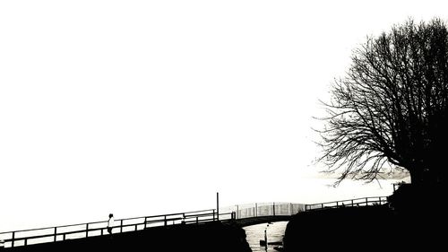 Silhouette of railing against clear sky