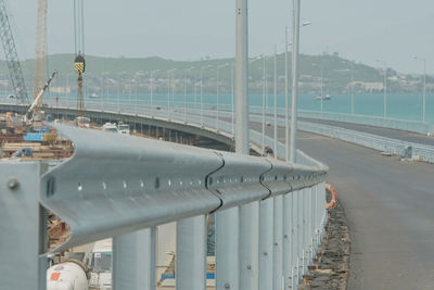 Bridge over sea against sky in city