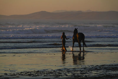 Friends standing on beach