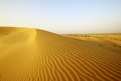 Scenic view of desert against clear sky