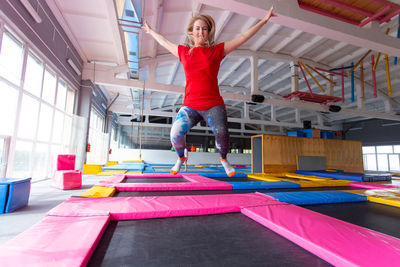 Full length portrait of woman jumping