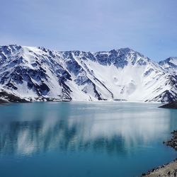 Scenic view of snowcapped mountains against blue sky