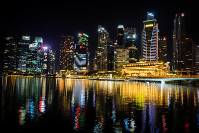Illuminated buildings against sky at night