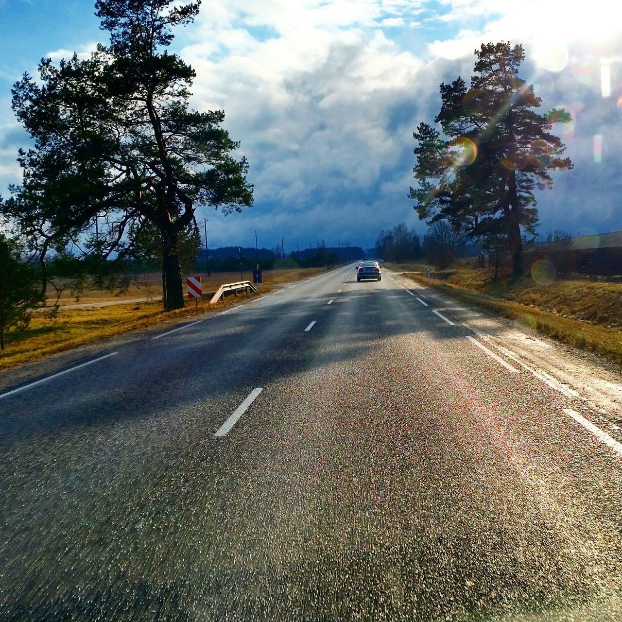 transportation, the way forward, road, tree, diminishing perspective, road marking, sky, land vehicle, car, mode of transport, vanishing point, street, country road, cloud - sky, asphalt, empty road, travel, on the move, outdoors, no people