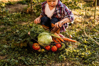 Midsection of man holding fruits