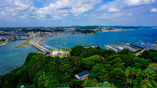 High angle view of buildings and sea against sky