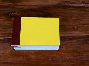 High angle view of yellow paper on table