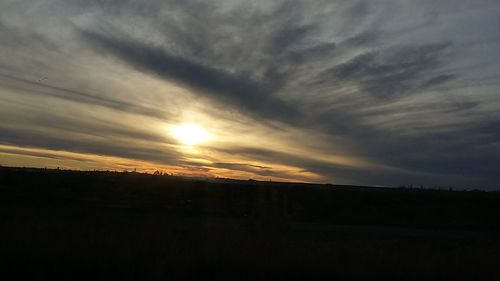 Scenic view of landscape against cloudy sky