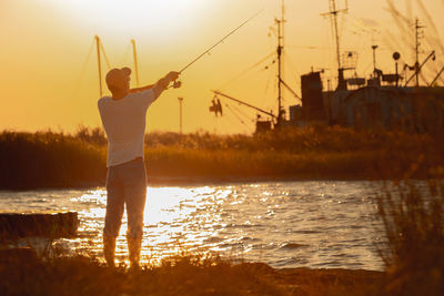 Rear view of man standing in sea