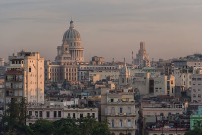 Capitolio by buildings against sky during sunset