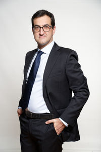 Portrait of man standing against white background