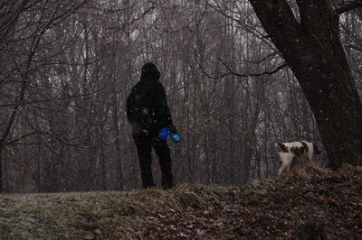 Man with dog in forest