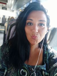 Portrait of beautiful young woman in car