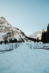 Scenic view of snowcapped mountains against clear sky