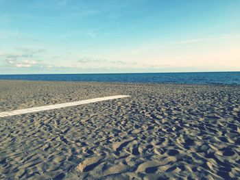 Scenic view of beach against blue sky
