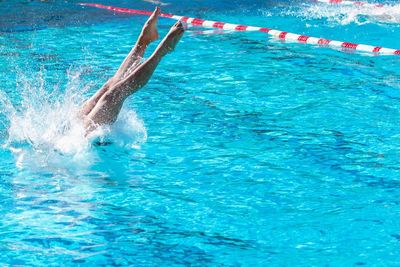 Woman diving into swimming pool