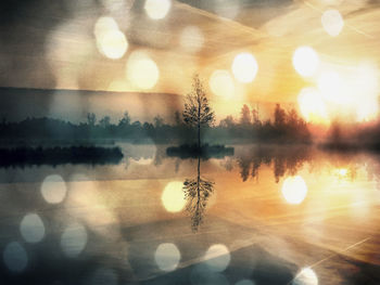 Digital composite image of lake and trees against sky during sunset
