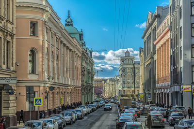 Vehicles on road along buildings