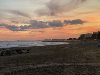 Scenic view of beach against sky during sunset