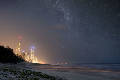 Scenic view of sea against star field at night