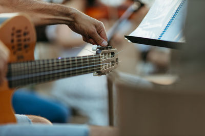 Close-up of person playing guitar