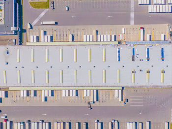 Aerial shot of industrial loading area where many trucks are unloading merchandis