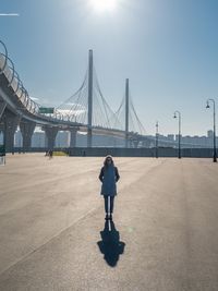 Rear view of woman standing on bridge