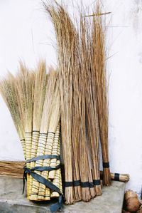 Broom stack on retaining wall