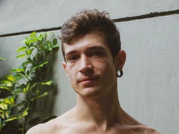 Portrait of young man against wall