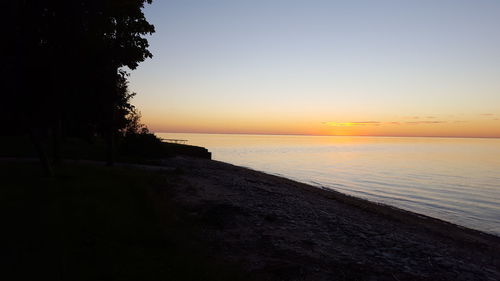 Scenic view of sea against clear sky during sunset