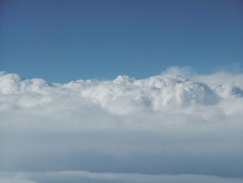 Low angle view of clouds in snow against sky