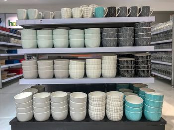 Various crockeries on shelf for sale in store