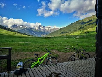 Bicycles on field against sky