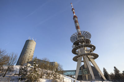 Low angle view of water tower against blue sky