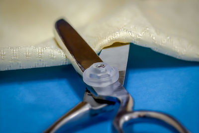 Close-up of scissor on fabric