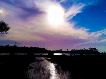 Scenic view of river at sunset