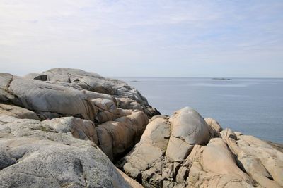 Rocks on beach against sky